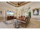 Elegant living room with tray ceilings, tile flooring, and a wall-mounted television at 18602 Ashcroft Cir, Port Charlotte, FL 33948