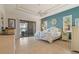 Serene main bedroom with tray ceiling, access to lanai, and a coastal aesthetic at 18602 Ashcroft Cir, Port Charlotte, FL 33948