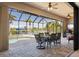 Enclosed outdoor dining space with screened lanai, canal view and pool at 18602 Ashcroft Cir, Port Charlotte, FL 33948
