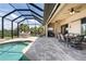 Covered pool and patio featuring outdoor seating, dining, and entertaining area at 18602 Ashcroft Cir, Port Charlotte, FL 33948