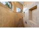 Corner shower features tiled walls, a built-in niche, a window, and a mosaic shower floor at 18602 Ashcroft Cir, Port Charlotte, FL 33948