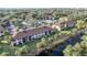 An aerial view of the condo buildings with waterfront views and mature trees at 19505 Quesada Ave # M104, Port Charlotte, FL 33948
