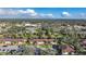 An aerial view of the community showcasing multiple condo buildings surrounded by lush greenery and trees at 19505 Quesada Ave # M104, Port Charlotte, FL 33948