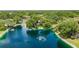 Aerial view of a lush community with a lake and fountain at 19505 Quesada Ave # M104, Port Charlotte, FL 33948