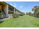 The condo's lush backyard features green space and water views at 19505 Quesada Ave # M104, Port Charlotte, FL 33948