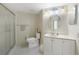 Well-lit bathroom with a shower, white tile floors, and modern vanity at 19505 Quesada Ave # M104, Port Charlotte, FL 33948