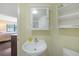 Compact bathroom with a white vanity, toilet, and view into bedroom space at 19505 Quesada Ave # M104, Port Charlotte, FL 33948