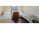 Inviting bedroom with two twin beds, laminate flooring, and natural light from a large window at 19505 Quesada Ave # M104, Port Charlotte, FL 33948