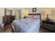 Relaxing bedroom with a queen-sized bed, dark wood furnishings, and calming neutral colors at 19505 Quesada Ave # M104, Port Charlotte, FL 33948