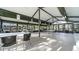 Large clubhouse area with tables, chairs, and bookshelves at 19505 Quesada Ave # M104, Port Charlotte, FL 33948
