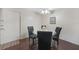 Bright dining area showcasing a round glass table, black chairs, and a nearby front door at 19505 Quesada Ave # M104, Port Charlotte, FL 33948