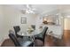 Open dining area featuring a modern glass table, seating for four, and views into the kitchen at 19505 Quesada Ave # M104, Port Charlotte, FL 33948