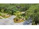 Community entrance featuring a gated entry, lush landscaping, and a well-manicured garden at 19505 Quesada Ave # M104, Port Charlotte, FL 33948