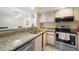 Functional kitchen layout with modern appliances and a breakfast bar at 19505 Quesada Ave # M104, Port Charlotte, FL 33948