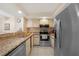 Well-equipped kitchen featuring stainless steel appliances and granite countertops at 19505 Quesada Ave # M104, Port Charlotte, FL 33948