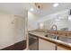 Bright kitchen featuring granite countertops, stainless steel dishwasher, and view into the living area at 19505 Quesada Ave # M104, Port Charlotte, FL 33948
