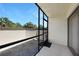Cozy screened-in patio with a view of the tropical landscape and blue sky at 19505 Quesada Ave # M104, Port Charlotte, FL 33948