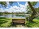 Bench overlooking the pond in this scenic community at 19505 Quesada Ave # M104, Port Charlotte, FL 33948