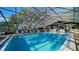 Enclosed swimming pool with plenty of lounge chairs for relaxing at 19505 Quesada Ave # M104, Port Charlotte, FL 33948