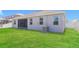The well-manicured backyard has an air conditioning unit and a screened in patio at 20067 Oakflower Ave, Tampa, FL 33647