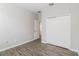 An airy bedroom featuring wood-look floors, a closet, a door, and neutral paint at 20067 Oakflower Ave, Tampa, FL 33647