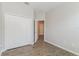 Well-lit bedroom features wood-style flooring, a spacious closet, and a doorway leading to another room in the house at 20067 Oakflower Ave, Tampa, FL 33647