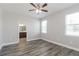 Bright bedroom features modern ceiling fan, wood-look floors, and an attached bathroom at 20067 Oakflower Ave, Tampa, FL 33647