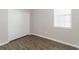 Comfortable bedroom with wood-style flooring, a window for natural light, and a spacious closet for storage at 20067 Oakflower Ave, Tampa, FL 33647