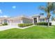 Charming single-story home with a well-manicured lawn, inviting entrance, and attached two car garage at 20067 Oakflower Ave, Tampa, FL 33647