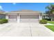 A spacious three car garage offers ample parking and storage with a large driveway in front of the home at 20067 Oakflower Ave, Tampa, FL 33647