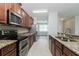 Well-equipped kitchen featuring modern appliances, granite countertops, and an efficient layout for cooking and entertaining at 20067 Oakflower Ave, Tampa, FL 33647