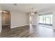 A spacious living room with wood-style floors, recessed lighting, and access to an outdoor screened-in patio at 20067 Oakflower Ave, Tampa, FL 33647