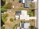 Birds eye view of property featuring a screened in pool, boat dock and canal access at 2008 Pellam Blvd, Port Charlotte, FL 33948