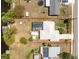 Birds eye view of property featuring a screened in pool, boat dock and canal access at 2008 Pellam Blvd, Port Charlotte, FL 33948