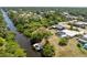Aerial shot showcasing the boat dock and pool, nestled in a lush waterfront neighborhood setting by the canal at 2008 Pellam Blvd, Port Charlotte, FL 33948