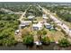 Wide aerial view of a charming waterfront property with a private dock and lush greenery at 2008 Pellam Blvd, Port Charlotte, FL 33948