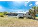 Spacious backyard features a screened-in pool area, RV, shed, and palm trees for a private oasis at 2008 Pellam Blvd, Port Charlotte, FL 33948