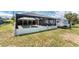 Spacious backyard features a screened-in pool area, RV, and fence line for added privacy at 2008 Pellam Blvd, Port Charlotte, FL 33948