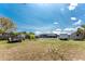 A spacious backyard featuring a screened-in pool, trailer, and lush greenery at 2008 Pellam Blvd, Port Charlotte, FL 33948