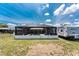 Screened-in backyard pool with a white fence and a travel trailer parked nearby at 2008 Pellam Blvd, Port Charlotte, FL 33948