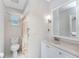 Bathroom with tiled floors, shower and vanity with a large mirror at 2008 Pellam Blvd, Port Charlotte, FL 33948