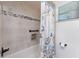 Bathroom featuring a shower with a nautical-themed shower curtain and tiled walls at 2008 Pellam Blvd, Port Charlotte, FL 33948