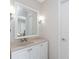 Bathroom with vanity and decorative lighting, with a mirror reflecting a view into the bedroom at 2008 Pellam Blvd, Port Charlotte, FL 33948