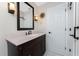 Bathroom featuring a dark wood vanity, decorative lighting, and tile flooring at 2008 Pellam Blvd, Port Charlotte, FL 33948