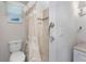 Bathroom featuring a shower with tile accents and grab bar for assistance and convenience at 2008 Pellam Blvd, Port Charlotte, FL 33948