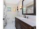 Bathroom featuring a vanity with dark wood and a shower with a nautical-themed curtain at 2008 Pellam Blvd, Port Charlotte, FL 33948