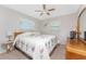 Well-lit bedroom with a comfortable bed, ceiling fan, and windows offering natural light at 2008 Pellam Blvd, Port Charlotte, FL 33948