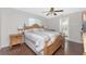 Cozy bedroom featuring a wooden bed frame, ceiling fan, and a view into the en-suite bathroom at 2008 Pellam Blvd, Port Charlotte, FL 33948