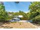 Scenic view of a private boat dock with a boat lift, surrounded by lush greenery and calm waters at 2008 Pellam Blvd, Port Charlotte, FL 33948
