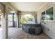 Relaxing hot tub on a covered patio, offering a tranquil escape with backyard view at 2008 Pellam Blvd, Port Charlotte, FL 33948